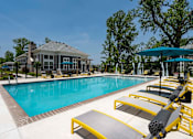 Thumbnail 47 of 49 - A pool with a yellow and black lounge chair.