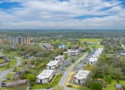 Thumbnail 25 of 25 - an aerial view of a city with a blue sky and white clouds