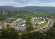 Thumbnail 40 of 41 - arial view of a neighborhood with trees and mountains in the background