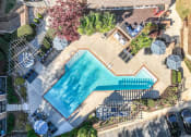 Thumbnail 25 of 31 - an aerial view of a swimming pool in a backyard with umbrellas