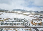 Thumbnail 40 of 43 - a city covered in snow with mountains in the background