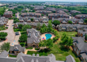 Thumbnail 65 of 69 - an aerial view of a neighborhood with houses and a swimming pool