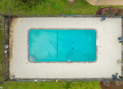 Thumbnail 21 of 25 - an aerial view of a swimming pool with green grass around it