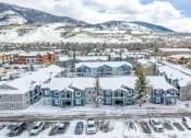 Thumbnail 31 of 43 - a city covered in snow with a mountain in the background