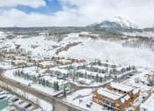 Thumbnail 43 of 43 - a city covered in snow with a mountain in the background