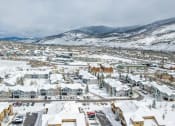 Thumbnail 37 of 43 - a city covered in snow with mountains in the background