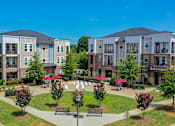 Thumbnail 50 of 53 - A sunny day at a residential complex with a park in the middle.