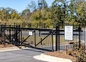 Thumbnail 40 of 45 - A black gate with a sign that says "Recreational Parking" and lists the types of vehicles allowed.