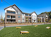 Thumbnail 34 of 45 - A row of modern houses with a green lawn in front.