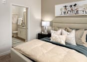 Thumbnail 15 of 45 - A bedroom with a large bed and a painting of sheep on the wall.