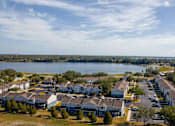 Thumbnail 15 of 15 - A large housing development with a body of water in the background.