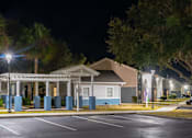 Thumbnail 9 of 15 - A building with a porch and lights on it.