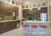 Thumbnail 27 of 35 - a kitchen with a center island and a stainless steel refrigerator
