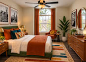 Thumbnail 5 of 20 - A bedroom with a bed, chair, and potted plants.