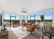 Thumbnail 27 of 34 - Huntsville, Al Luxury Apartments for Rent - The Arcadia - Living Room with Luxury Vinyl Plank Flooring, Area Rug, Sofa, Two-Seater Settee, Armchair, Coffee Table, Media Cabinet, Wall-Mounted TV, 9-foot Ceiling, Ceiling Fan, and Floor-to-Ceiling Windows with Expansive Views.