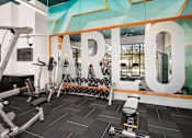 Thumbnail 47 of 57 - a gym with weights and cardio machines and a large sign with the word rehab on
