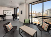 Thumbnail 42 of 57 - a living room with chairs and a table and a view of the city