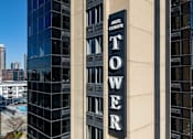 Thumbnail 28 of 32 - A tall building with a sign that says "Tower Center".