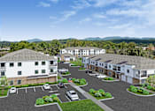 Thumbnail 35 of 35 - A large white building with a parking lot in front of it.