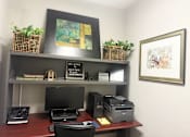 Thumbnail 19 of 23 - A black monitor and a black printer on a desk with a sign that says "We Welcome Ashford Place Apartments".