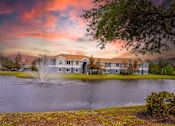 Thumbnail 42 of 43 - A house with a fountain in front of it.