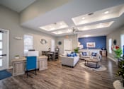 Thumbnail 12 of 43 - A living room with a blue accent wall and a white couch.