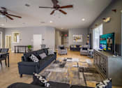 Thumbnail 13 of 43 - A living room with a ceiling fan and a rug on the floor.