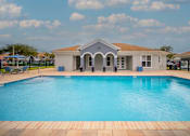 Thumbnail 3 of 43 - A swimming pool in front of a house.