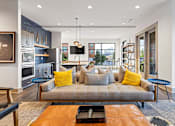 Thumbnail 14 of 31 - a living room with a couch and a kitchen