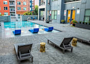 Thumbnail 26 of 31 - a pool of water in a courtyard with benches and chairs