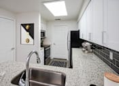 Thumbnail 13 of 36 - a kitchen with a sink and a refrigerator
