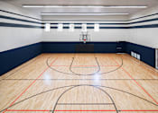 Thumbnail 30 of 36 - a basketball court in a gym at a school
