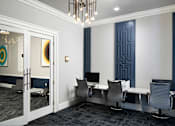Thumbnail 8 of 36 - a conference room with desks and chairs and a chandelier