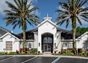 Thumbnail 35 of 36 - a building with palm trees in front of it