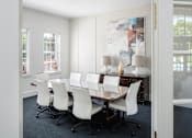 Thumbnail 5 of 36 - a dining room with a table and chairs and a painting on the wall