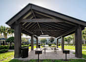 Thumbnail 26 of 36 - a pavilion with benches in a park