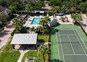 Thumbnail 33 of 36 - an aerial view of a tennis court and a pool in the backyard of a house