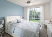 Thumbnail 16 of 36 - a blue and white bedroom with a bed and a window
