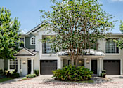 Thumbnail 32 of 36 - the exterior of a house with a tree in front of it