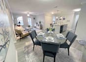 Thumbnail 12 of 24 - A dining room with a table set for six.