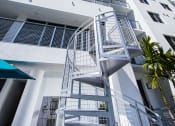 Thumbnail 29 of 30 - a white apartment building with a spiral staircase in front of a blue sky at Saba Pompano Beach, Pompano Beach, 33062