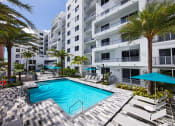 Thumbnail 5 of 30 - a swimming pool in front of a building with palm trees at Saba Pompano Beach, Pompano Beach, 33062