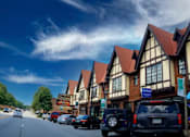 Thumbnail 18 of 18 - a row of houses with cars parked in front of them at Avondale Station Apartments, Georgia