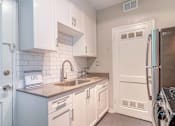 Thumbnail 6 of 18 - a kitchen with cabinets and stainless steel appliances at Avondale Station Apartments, Decatur, 30030