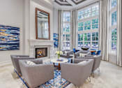 Thumbnail 9 of 20 - A living room with a fireplace and a painting on the wall.