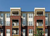 Thumbnail 17 of 20 - Apartment building with balconies and windows.