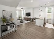 Thumbnail 15 of 50 - a living room with a kitchen and a television