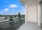 Thumbnail 25 of 35 - A balcony with a metal railing and a view of the outdoors.