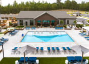 Thumbnail 40 of 70 - an aerial view of a pool with lounge chairs and a building