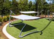Thumbnail 53 of 70 - a hammock area in a park with trees in the background